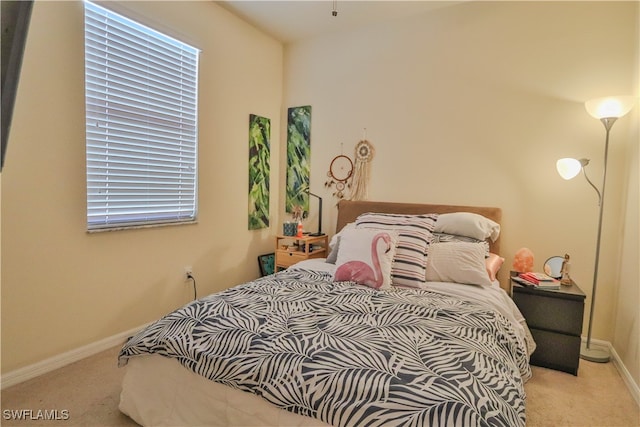 bedroom featuring light colored carpet