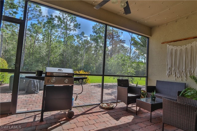 sunroom / solarium with ceiling fan and a wealth of natural light