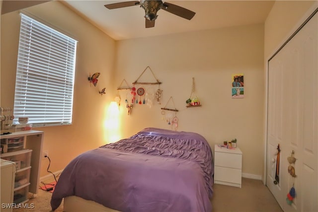 bedroom with a closet, light colored carpet, and ceiling fan