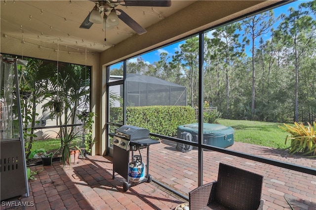 sunroom featuring ceiling fan