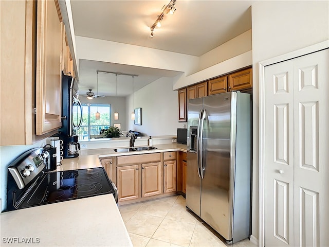 kitchen with track lighting, sink, light tile patterned floors, appliances with stainless steel finishes, and ceiling fan