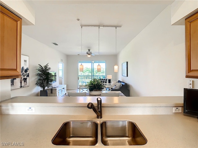 kitchen with rail lighting, ceiling fan, and sink