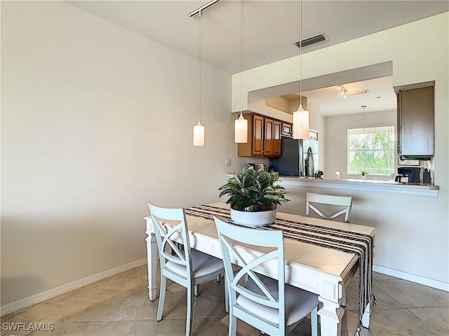 tiled dining area with track lighting