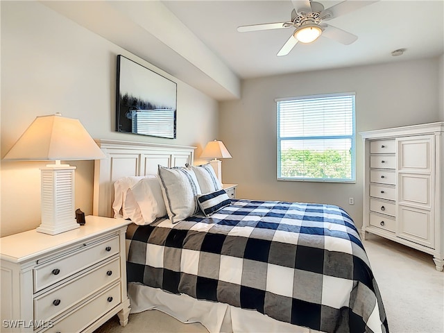 bedroom featuring light colored carpet and ceiling fan