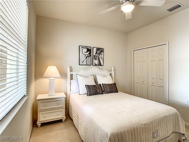 carpeted bedroom with a closet and ceiling fan