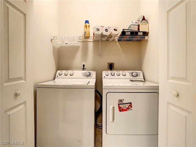 clothes washing area featuring washer and dryer