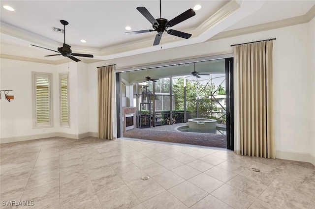 unfurnished room with a raised ceiling and crown molding