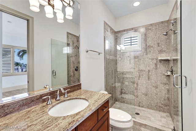 bathroom with vanity, toilet, and an enclosed shower