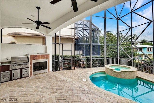 view of pool featuring ceiling fan, a patio, exterior kitchen, area for grilling, and glass enclosure