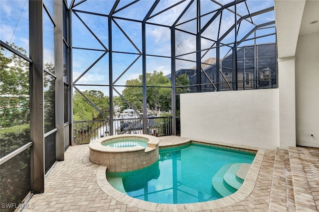 view of swimming pool with glass enclosure, a patio, and an in ground hot tub