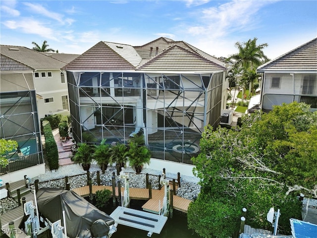 back of property featuring glass enclosure