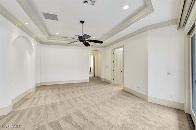 27588 River Reach Dr, Bonita Springs, FL 34134 - empty room featuring light carpet, a tray ceiling, ceiling fan, arched walkways, and crown molding