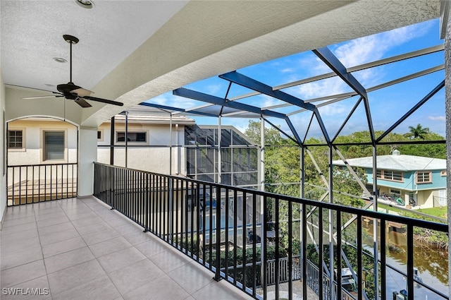 exterior space with a water view and ceiling fan