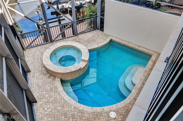 view of swimming pool featuring an in ground hot tub