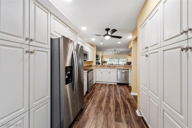 kitchen with dark hardwood / wood-style floors, white cabinetry, ceiling fan, kitchen peninsula, and stainless steel appliances