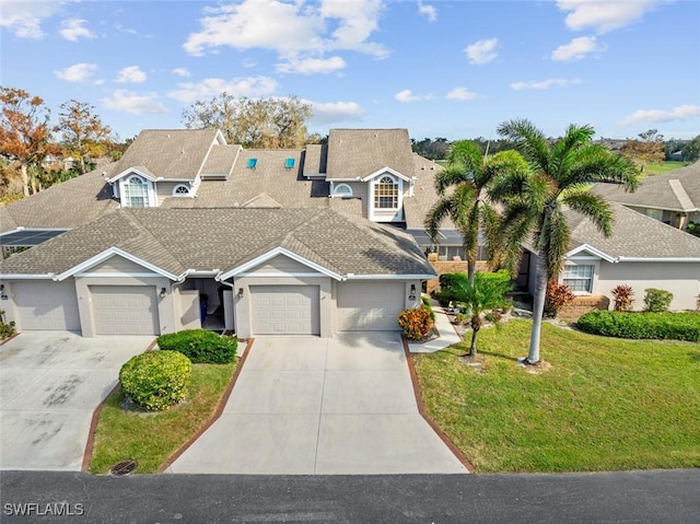 view of front of home with a garage and a front lawn