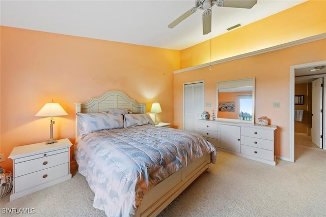 bedroom featuring light carpet, a closet, and ceiling fan