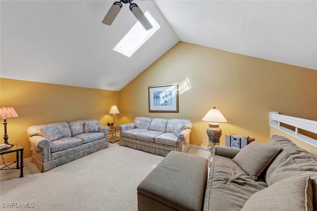 carpeted living room featuring lofted ceiling with skylight and ceiling fan