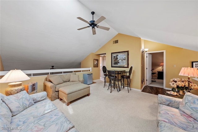 carpeted living room featuring vaulted ceiling and ceiling fan