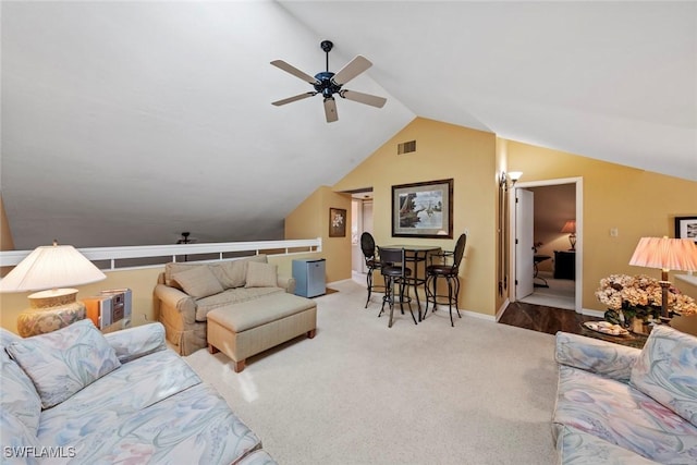 living room featuring vaulted ceiling, ceiling fan, and carpet flooring