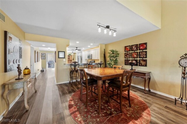 dining area with ceiling fan and hardwood / wood-style floors