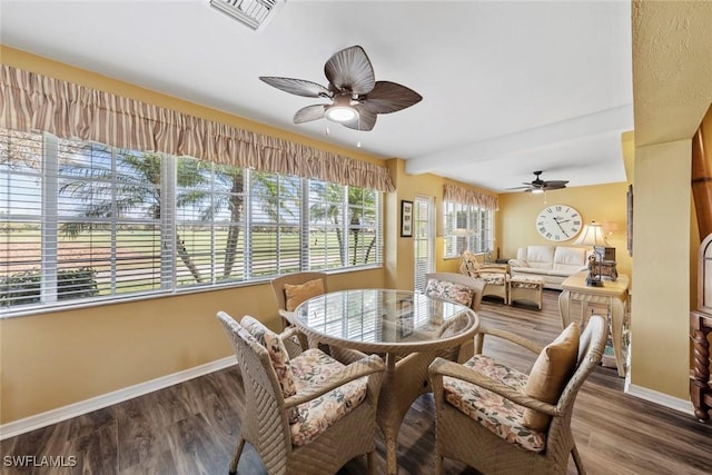 dining space with hardwood / wood-style floors and ceiling fan