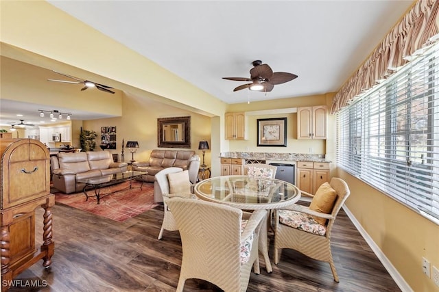 dining area featuring ceiling fan and dark hardwood / wood-style floors