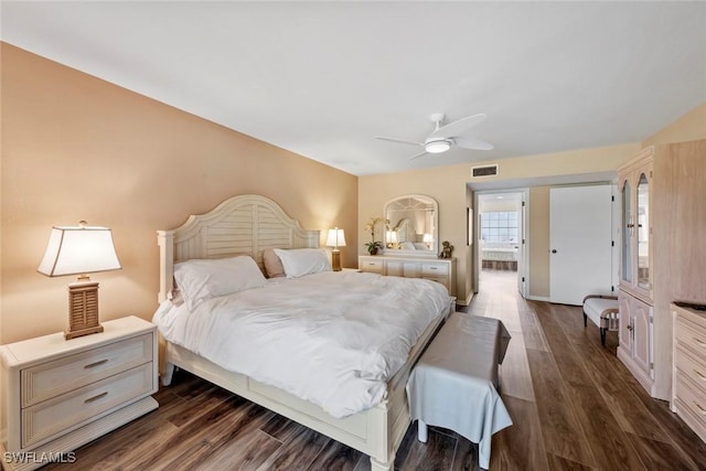 bedroom with dark hardwood / wood-style flooring and ceiling fan