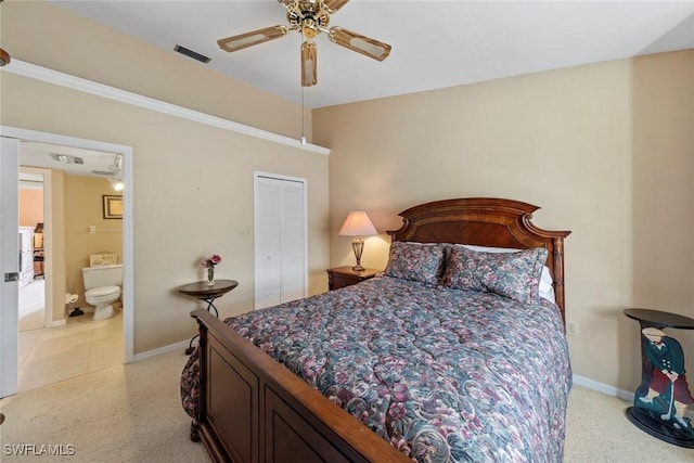 carpeted bedroom with a closet, ceiling fan, and ensuite bathroom