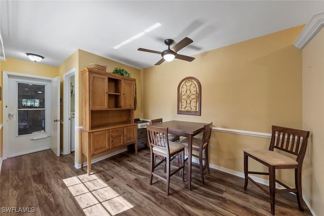 dining space featuring ceiling fan and dark hardwood / wood-style flooring