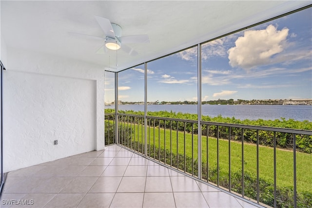 unfurnished sunroom with a water view and ceiling fan