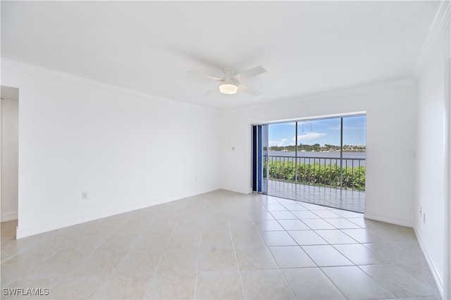 spare room with light tile patterned floors, a water view, ceiling fan, and crown molding