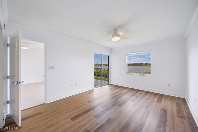 unfurnished room featuring ceiling fan, wood-type flooring, and ornamental molding