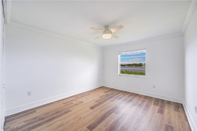 unfurnished room with ceiling fan, light hardwood / wood-style flooring, and ornamental molding