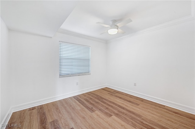 spare room featuring hardwood / wood-style flooring, ceiling fan, and crown molding