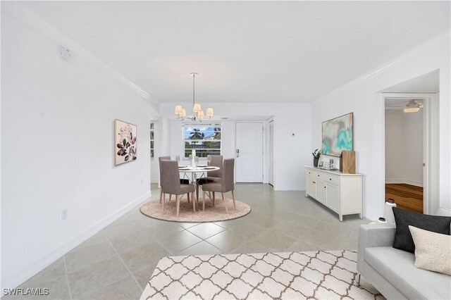 dining area featuring ceiling fan with notable chandelier and crown molding