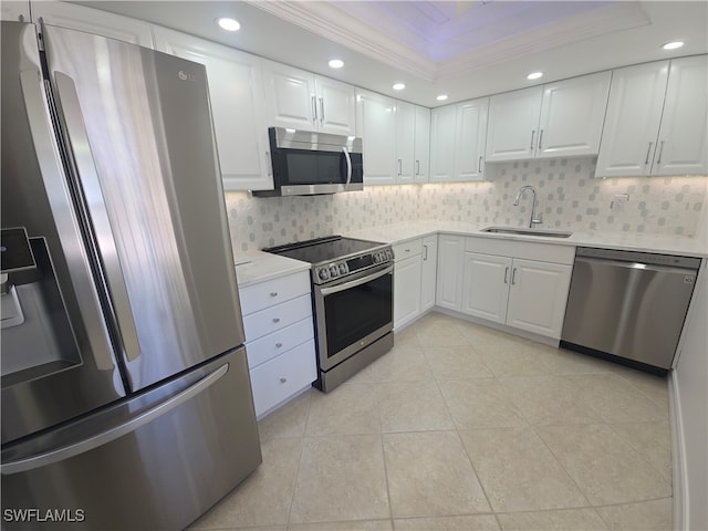 kitchen featuring stainless steel appliances, white cabinetry, ornamental molding, and sink