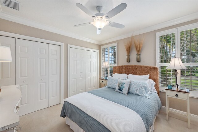 carpeted bedroom featuring multiple windows, ceiling fan, and crown molding