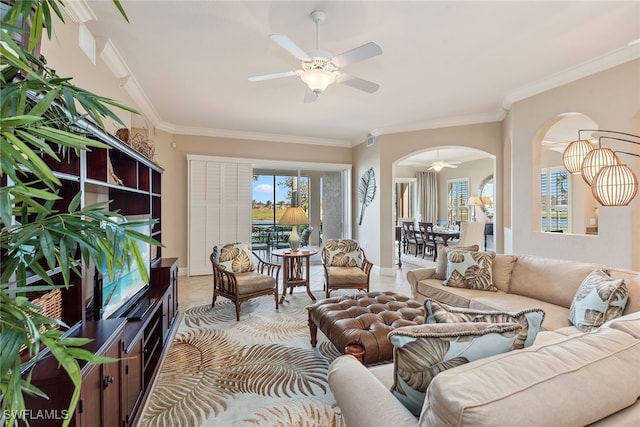 living room with ceiling fan and ornamental molding