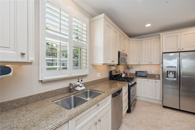 kitchen with white cabinetry, sink, light tile patterned floors, and stainless steel appliances