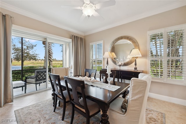 tiled dining area with plenty of natural light, ceiling fan, and ornamental molding