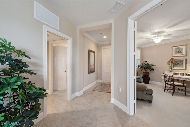 hallway featuring light tile patterned floors and ornamental molding