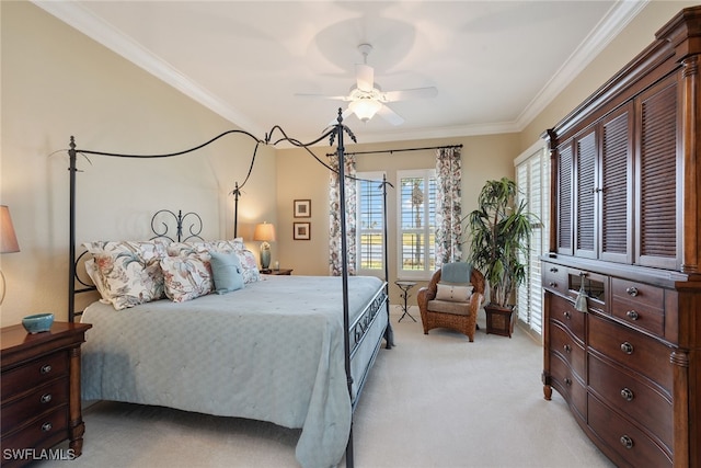 carpeted bedroom with ceiling fan and ornamental molding