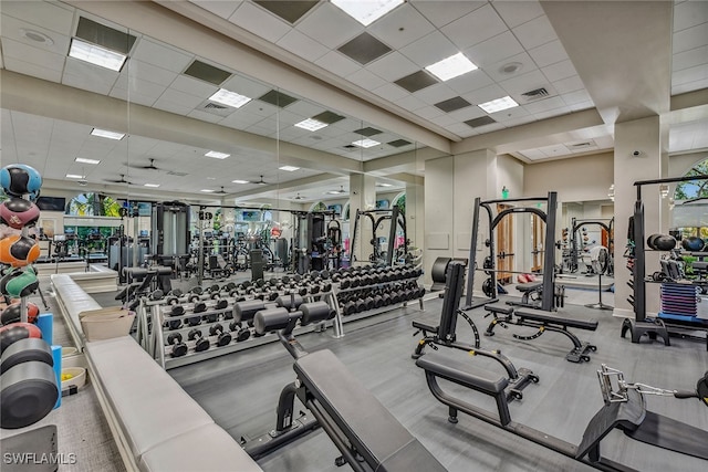 gym featuring a paneled ceiling and plenty of natural light