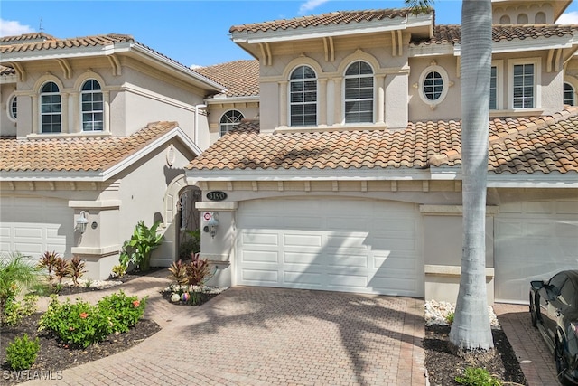 mediterranean / spanish home featuring a garage