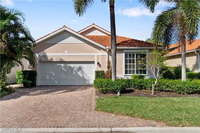 view of front facade with a garage and a front yard