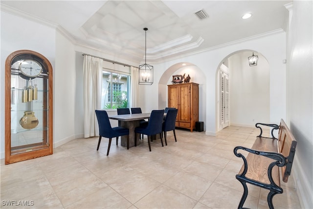 tiled dining area with a tray ceiling, an inviting chandelier, and ornamental molding