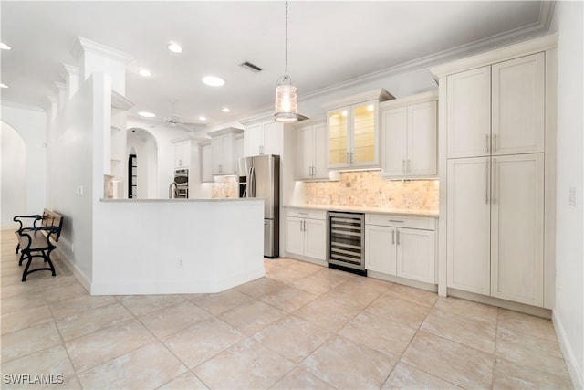 kitchen featuring stainless steel appliances, backsplash, pendant lighting, beverage cooler, and ceiling fan