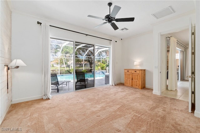 interior space with ceiling fan and crown molding