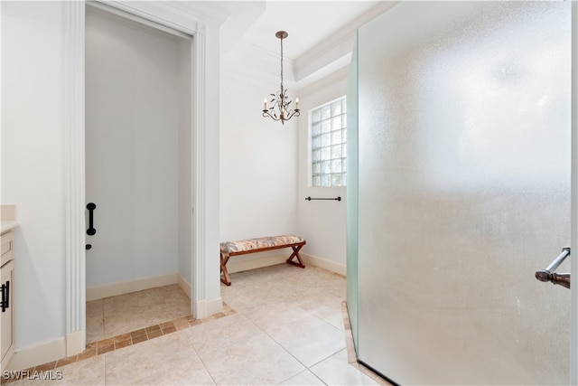 bathroom with vanity, an inviting chandelier, and tile patterned floors